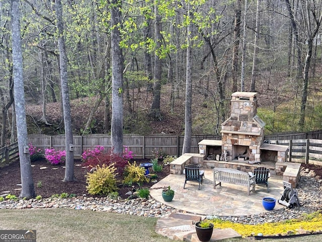 view of patio with an outdoor stone fireplace