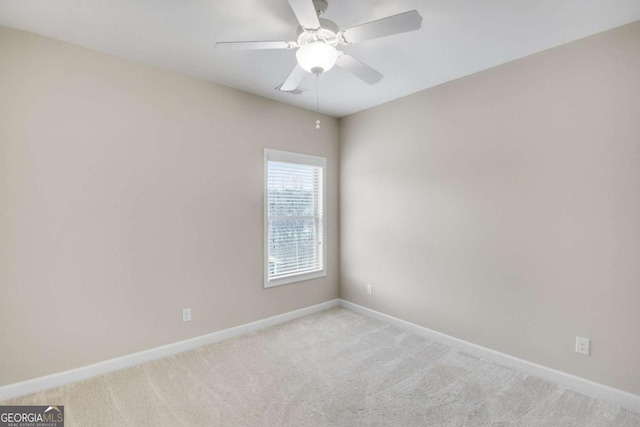 carpeted empty room featuring ceiling fan