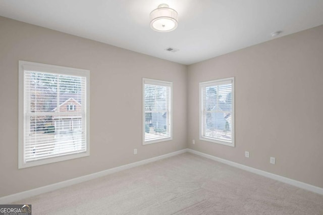 empty room with light colored carpet