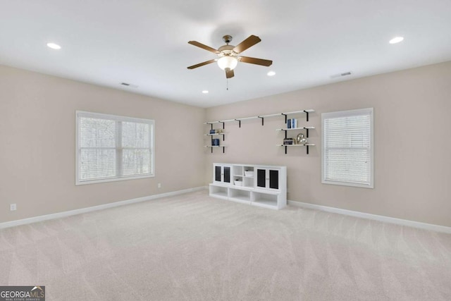 unfurnished living room with ceiling fan and light carpet