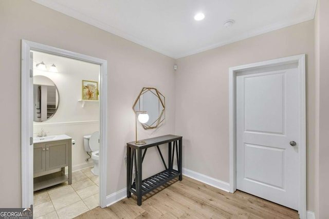 hall featuring sink and light hardwood / wood-style flooring