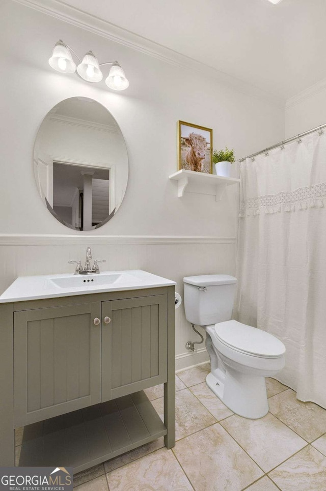 bathroom with ornamental molding, vanity, tile patterned floors, and toilet