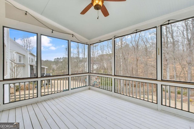 unfurnished sunroom with ceiling fan and lofted ceiling