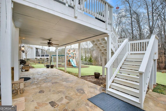 view of patio with ceiling fan and a playground