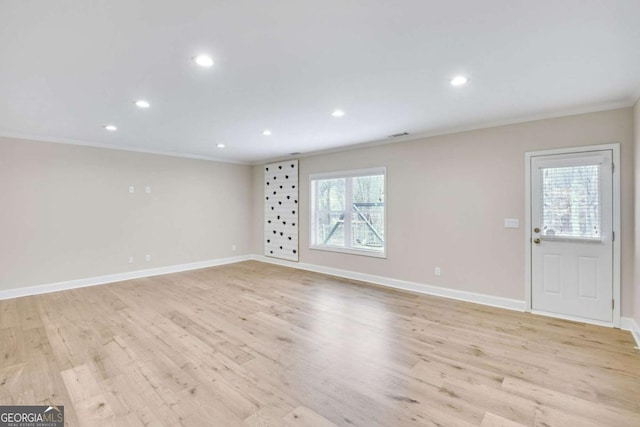 interior space with ornamental molding and light hardwood / wood-style floors