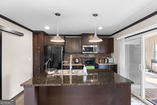 kitchen with dark brown cabinetry, a kitchen island with sink, black appliances, and dark stone countertops