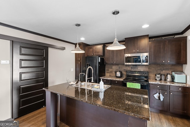 kitchen with dark stone counters, pendant lighting, dark brown cabinetry, and black appliances