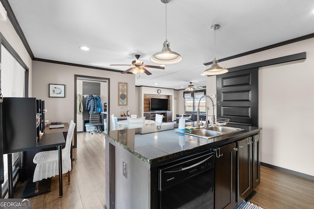 kitchen with pendant lighting, an island with sink, black dishwasher, sink, and ornamental molding