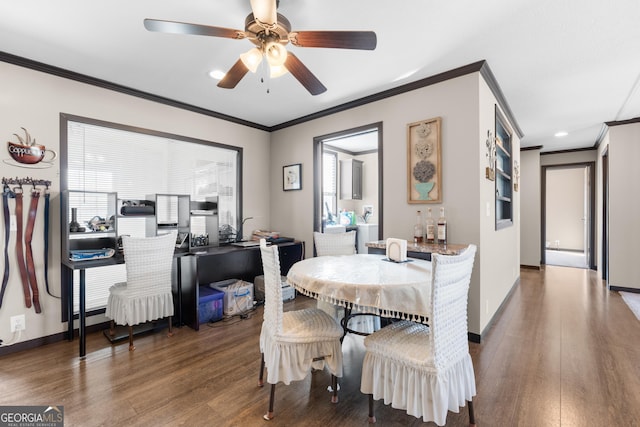 dining room featuring dark wood-type flooring, ceiling fan, and crown molding