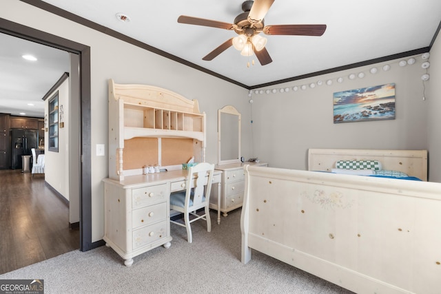 bedroom with black fridge with ice dispenser, ornamental molding, ceiling fan, and carpet