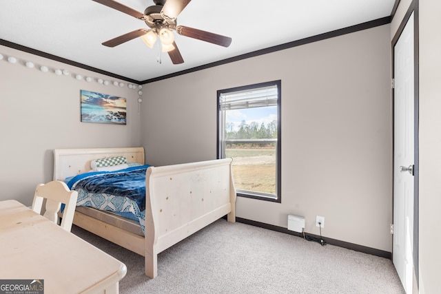 carpeted bedroom featuring crown molding and ceiling fan