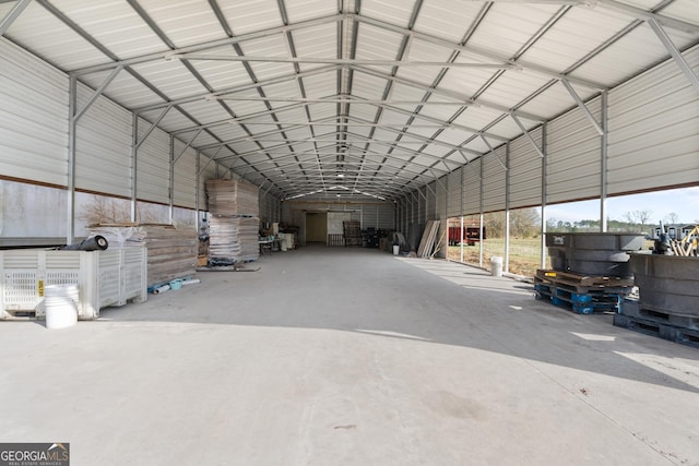 miscellaneous room featuring lofted ceiling and concrete flooring