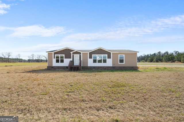 view of front of property with a rural view and a front yard