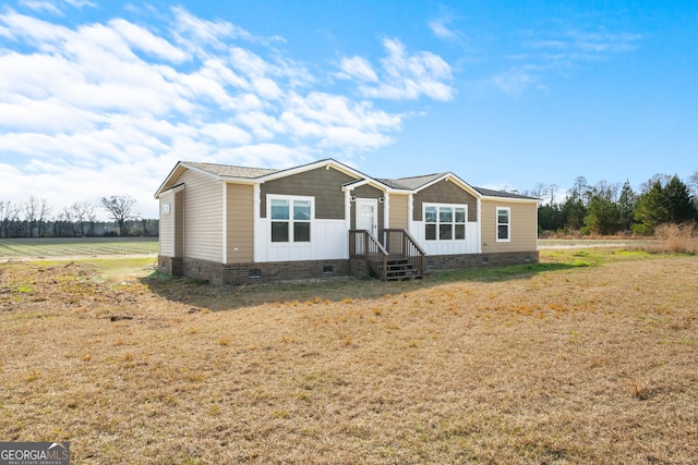 manufactured / mobile home with a front lawn and a rural view