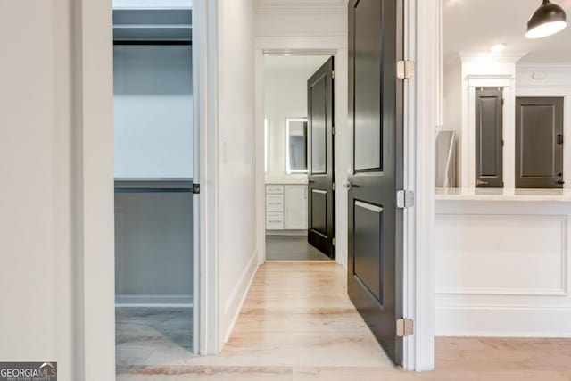 hall featuring crown molding and light wood-type flooring