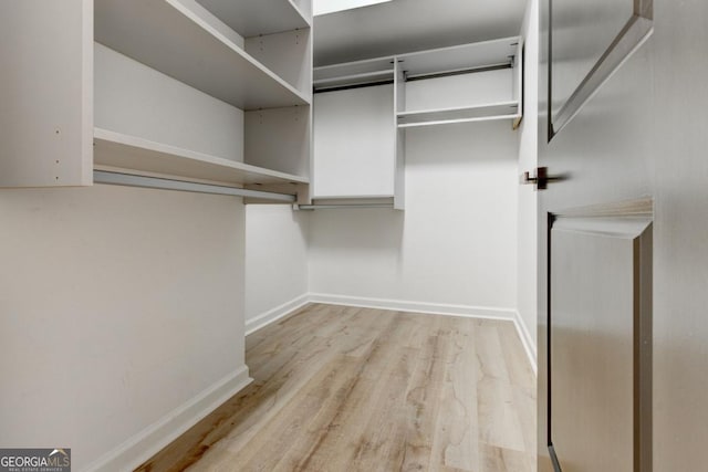 spacious closet featuring light wood-type flooring