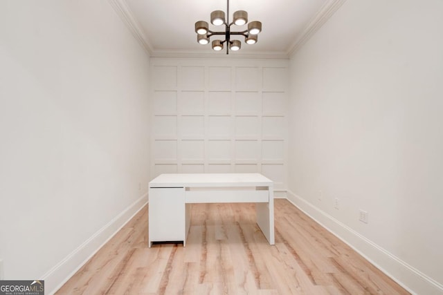 unfurnished office with crown molding, a chandelier, and light wood-type flooring