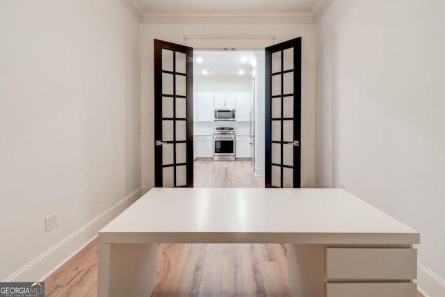 interior space featuring stainless steel appliances, wood-type flooring, and crown molding