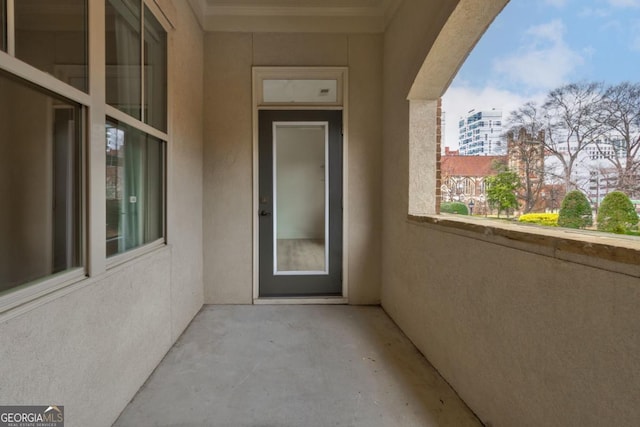 view of exterior entry featuring a balcony