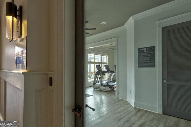 hall featuring crown molding and light hardwood / wood-style floors