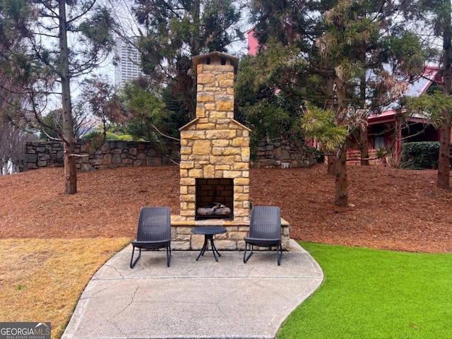 view of patio with an outdoor stone fireplace