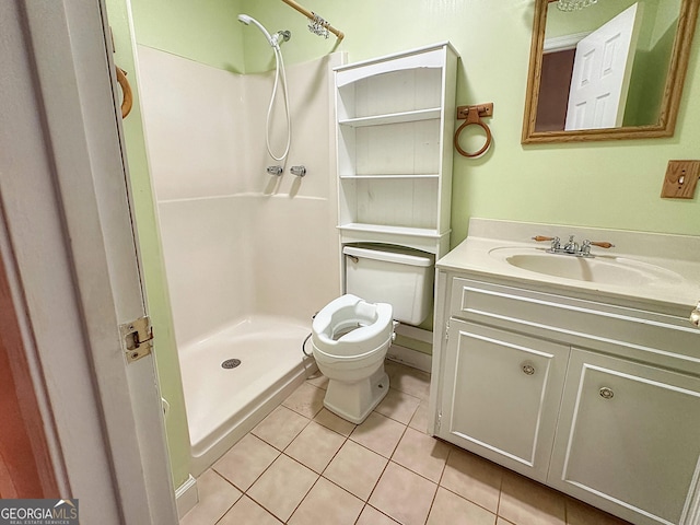 bathroom featuring tile patterned flooring, vanity, toilet, and walk in shower