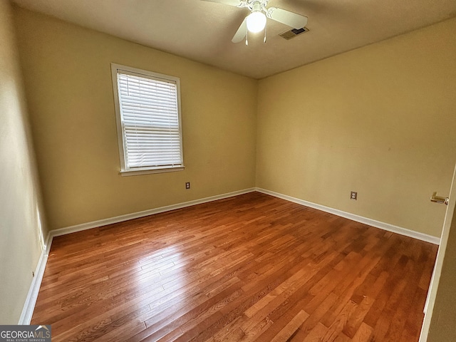 empty room featuring wood-type flooring and ceiling fan