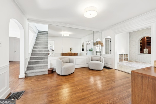 living room featuring crown molding and wood-type flooring