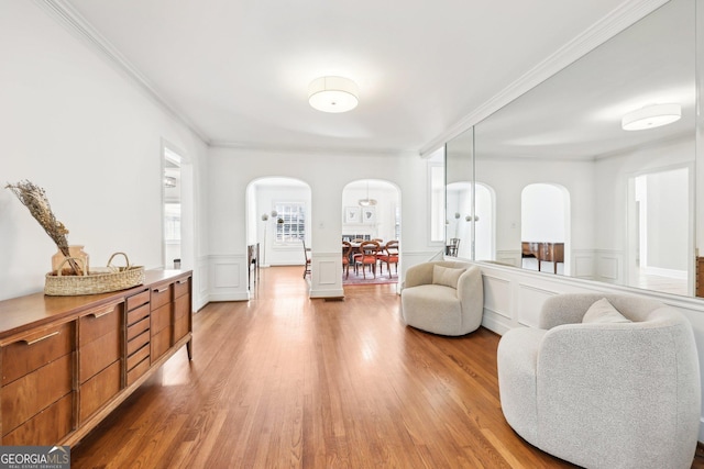 sitting room featuring wood-type flooring and ornamental molding