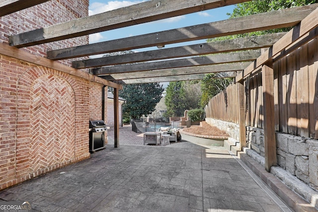 view of patio / terrace with area for grilling and a pergola