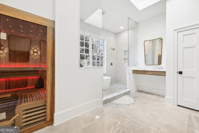 bathroom featuring vanity, shower with separate bathtub, and a skylight