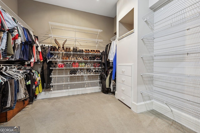 walk in closet featuring carpet