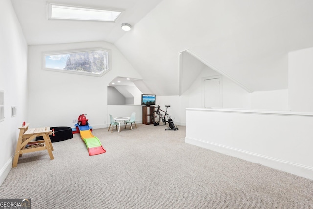 rec room with lofted ceiling with skylight and carpet floors