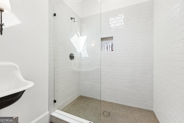 bathroom featuring sink and a shower with door