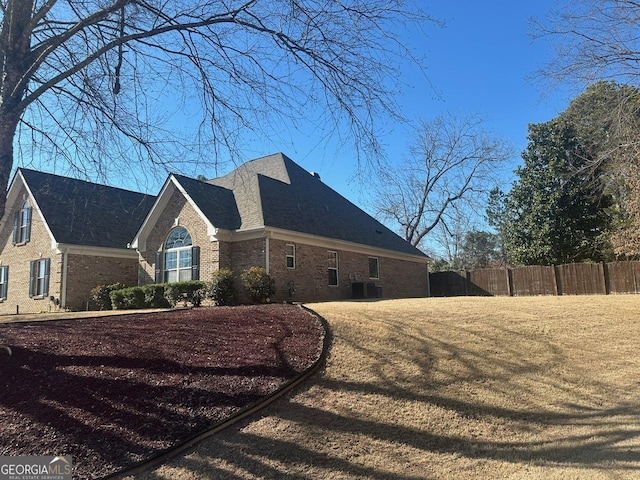 view of property exterior with a yard