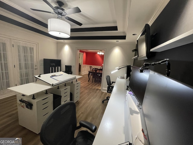 home office with dark hardwood / wood-style flooring, a tray ceiling, crown molding, and ceiling fan