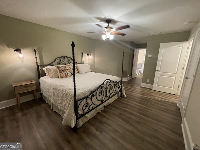 bedroom with dark hardwood / wood-style floors and ceiling fan