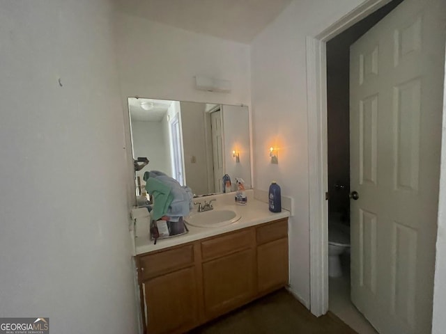 bathroom featuring vanity and toilet