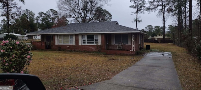 view of front of home with a porch and a front yard