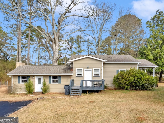 view of front of house featuring a front yard and a deck