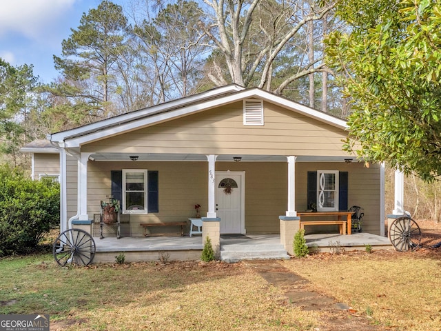 bungalow-style house featuring a porch and a front yard