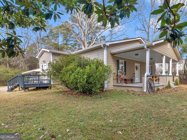 view of side of home featuring a porch, a deck, and a lawn