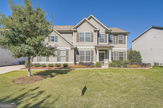 view of front of home featuring cooling unit and a front lawn