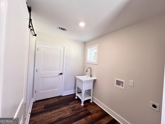 washroom with a barn door, hookup for a washing machine, laundry area, visible vents, and electric dryer hookup