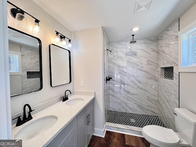 bathroom featuring visible vents, a sink, toilet, and wood finished floors