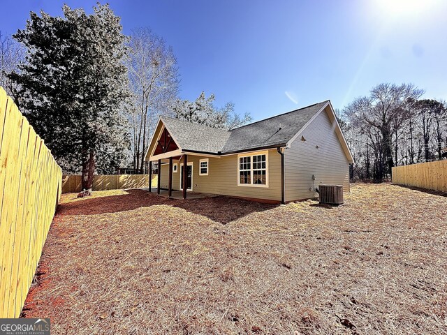 rear view of property featuring cooling unit and a patio area