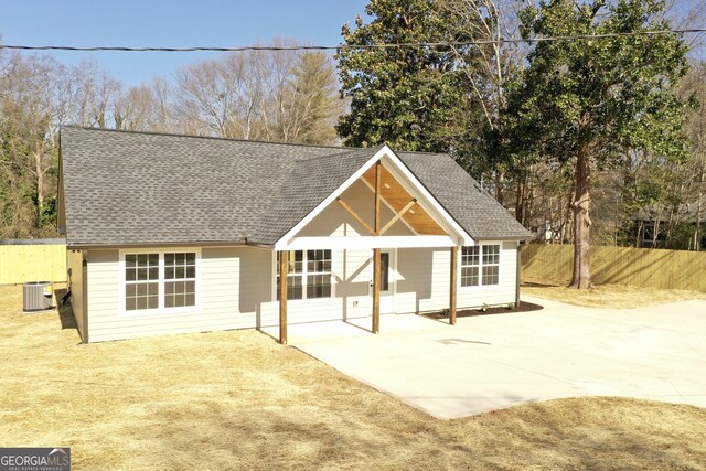 view of front of house with cooling unit and a patio