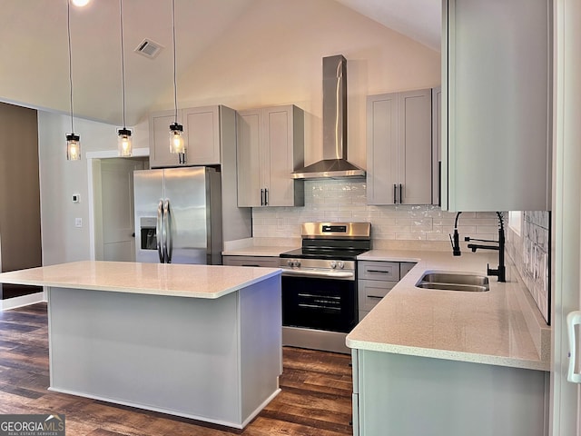 kitchen featuring dark wood finished floors, stainless steel appliances, gray cabinets, visible vents, and wall chimney exhaust hood