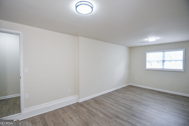 unfurnished room featuring hardwood / wood-style flooring