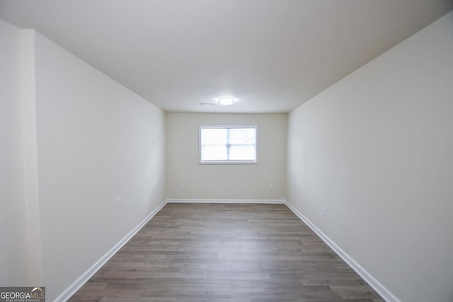 spare room with wood-type flooring